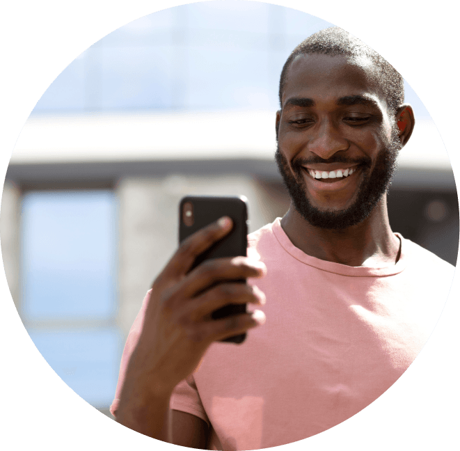 Person smiling while looking at phone