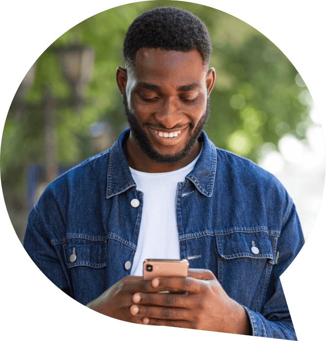 Person smiling while looking at phone